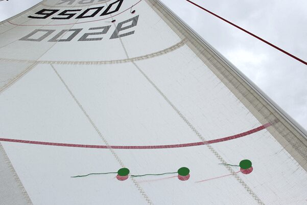 Photo of sail telltales streaming correctly on a mainsail and jib